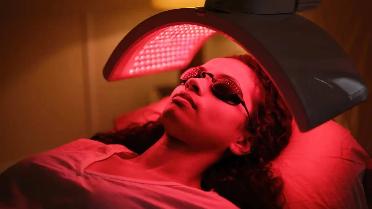 A woman is receiving red light therapy at TrueU in Chico, California